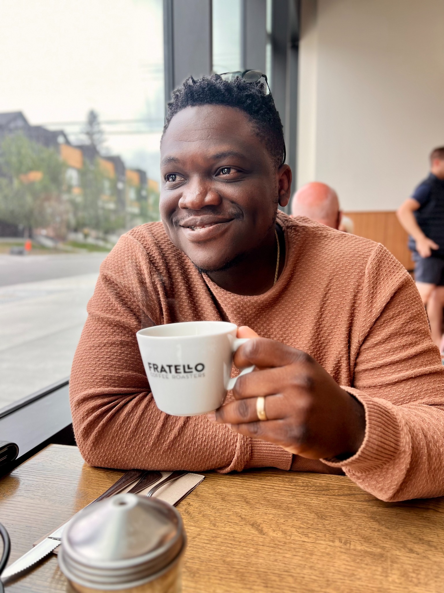 David Abolarin seated in a café